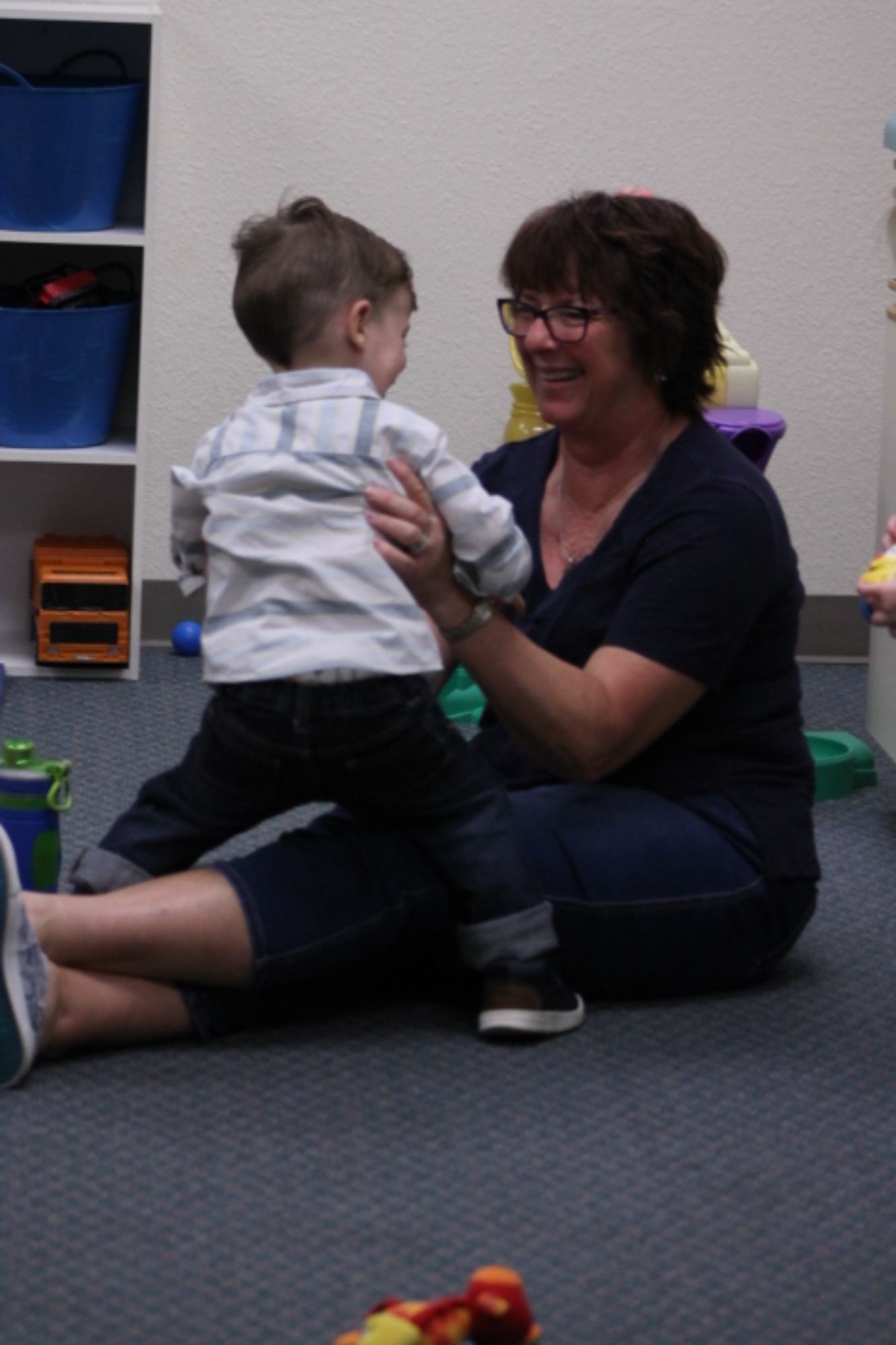 woman-playing-with-small-child-in-church-nursery